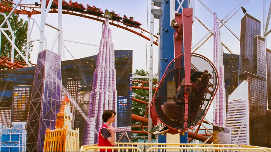 Corkscrew in the background of a shot. The main characters are loading into the ride 'Cranium Shaker