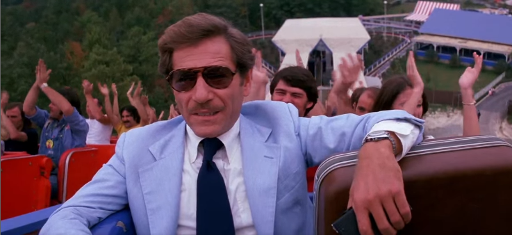 George Segal on Rebel Yell, he's holding a brown breifcase next to him with his elbow.