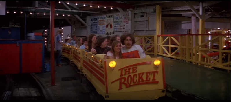 The Rocket's train pulling into the station, the train is yellow with red text on the front that reads The Rocket