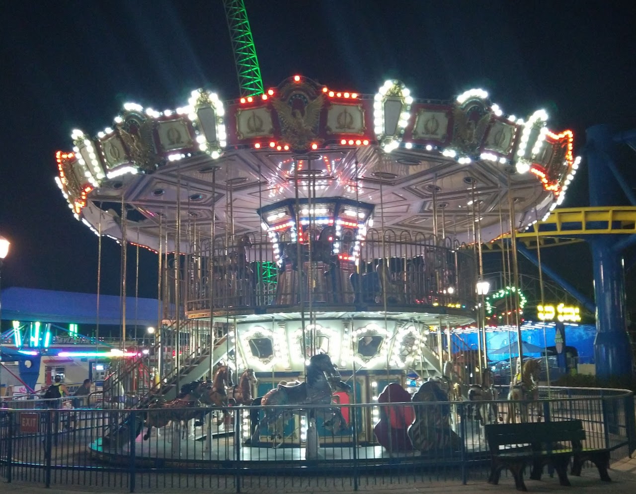Double decker carousel at night, all the lights are on